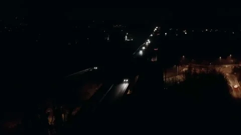 4k aerial flying behind drone footage of night autobahn car traffic with yellow Stock Footage 168539523