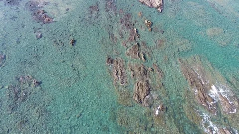 4K aerial flyover view of the ocean rocky coastline with waves by drone Stock Footage 257791476