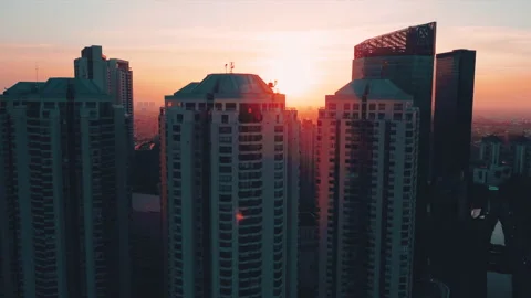 4K Aerial Footage of Beautiful Urban Sunset over Tall buildings Stock Footage