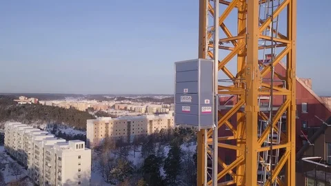 4K Aerial Footage of an elevator on a tower crane pulls out wide to show entire Video stock 93142606