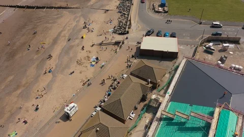 4K Aerial footage looking down at families on sandy Hornsea Beach Stock Footage 113808057