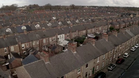 4K aerial footage of the rooftops of back to back terraced houses in the UK Video stock 223901060