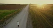 4K Aerial Footage Of A Runner At The Fields At The Sunset. Stock Footage