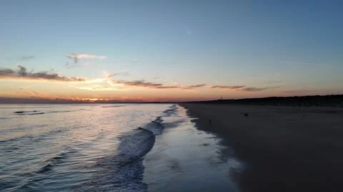 4K Aerial: Forward flight over Huelva beach with left turn at sunset. Stock Footage 333637522