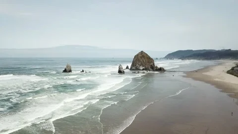 4K Aerial of Haystack Rock on Cannon Beach, Oregon - Pacific Northwest Stock Footage 135553591