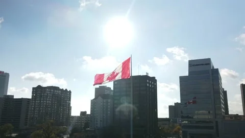 4K Aerial Hyperlapse rotating around giant Canadian flag waving in the wind on W Stock Footage 149900458