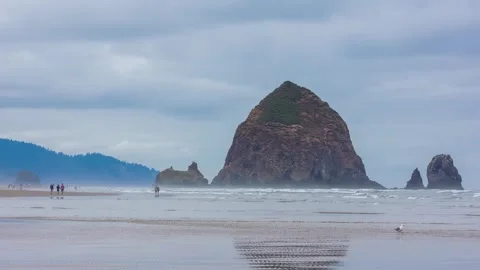 4K Aerial of Iconic Haystack Rock at Cannon Beach, Oregon's Scenic Pacific Shore Stock Footage 309279223