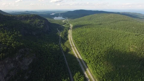 4K aerial of an interstate highway in the Adirondacks mountains, upstate New Stock Footage 89505573