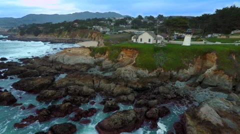 4k Aerial Lighthouse on a cliff over Pacific Ocean rocks and waves California Stock Footage 60944119