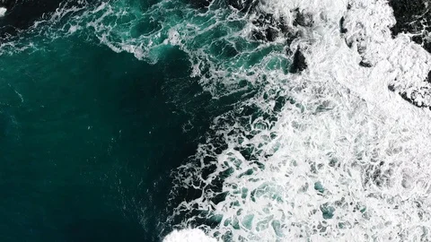 4k Aerial looking straight down over waves breaking on rocky coast ireland 動画素材 89236471