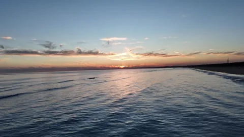 4K Aerial: Low angle drone flight over waves at sunset in Punta Umbria. Stock Footage 333637662
