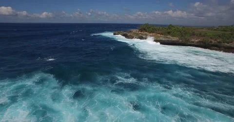 4K AERIAL LOW ANGLE FLY OVER OF DEEP BLUE OCEAN ROCK CLIFFS Stock Footage 60004146