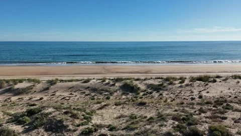 4K Aerial: Low flight over protected sand dunes and wild beach in Andalusia. Stock Footage 333637585