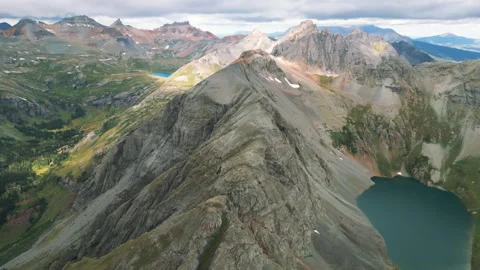 4K Aerial Mountain Peak Summit Blue Lake Fly Over Hiking Stock Footage 300056657