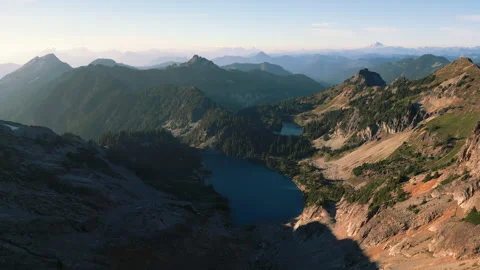4K Aerial Mountain Peak Summit Blue Lake Fly Over Stock Footage 300056691