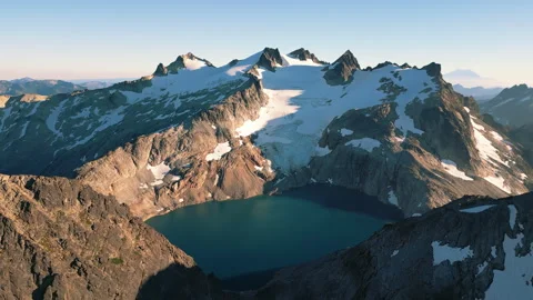 4K Aerial Mountain Peak Summit Glacier Blue Lake Fly Over Stock Footage 300056766