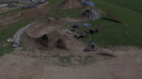4k aerial mtb smooth jump line Stock Footage 64207643