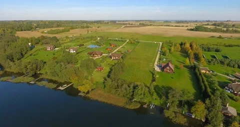 4K Aerial nature landscape fields lakes forests houses cottages Vídeos de archivo 106554544