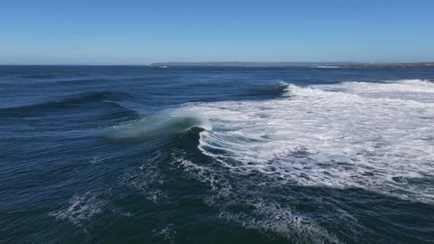 4K Aerial Ocean Wave Breaking Near Coastal Shoreline Stock Footage 333704040