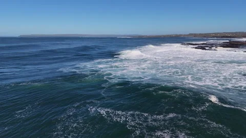 4K Aerial Ocean Wave Breaking Near Coastal Shoreline Stock Footage 333704047