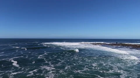 4K Aerial Ocean Waves and Sea Foam Under Blue Sky Stock Footage 333703885