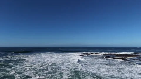 4K Aerial Ocean Waves and Sea Foam Under Blue Sky Stock-Footage 333703889
