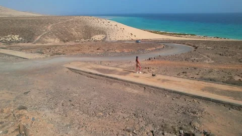 4K-Aerial orbit drone view Lady looking ocean Mirador del Salmo Fuerteventura Stock Footage 171074626