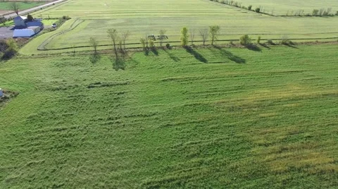 4k aerial over fields and tractor working Stock Footage 55602515