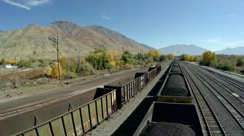 4K Aerial over moving train pulling coal Stock Footage 42945626