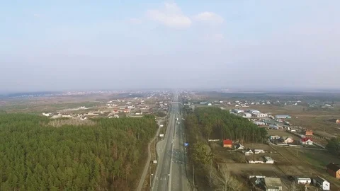 4K Aerial. Over suburb equal highway and wood.Panorama Stockbeeldmateriaal 73486756