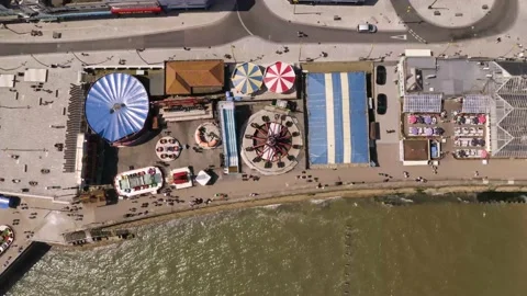 4K aerial overhead view of a typical British seaside funfair or amusements Video stock 157442540