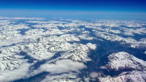 4K Aerial Perspective Snow Covered Mountain Peaks And Cloud Formations Video stock 334447887