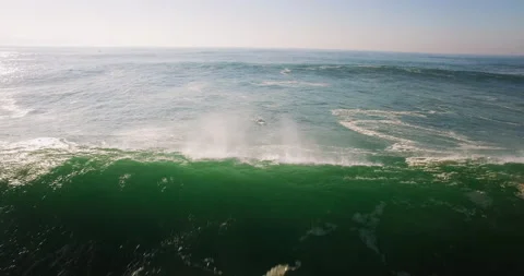 4K aerial of pro Red Chargers surfer riding giant ocean wave on surfboard Stock Footage
