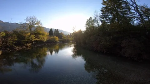 4K AERIAL Rising above a mountain river at sunset Stock Footage 118011553