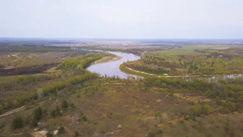           4K  Aerial. River and fields. Landscape. Nature shoot Stockbeeldmateriaal 129823665