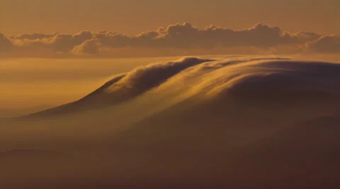 4K aerial, rolling cloud vortex over mountain top at sunrise dawn Stock Footage 45287840