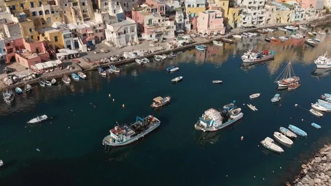 4K aerial shot of boat coming into Procida harbor Stock Footage