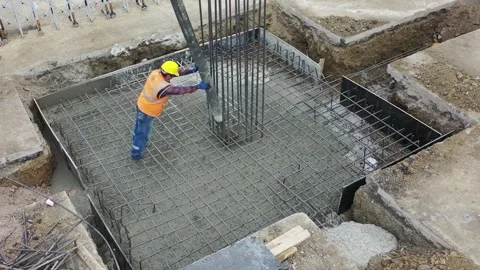 4K Aerial shot construction worker pouring concrete at construction site basis Stock Footage 162959274