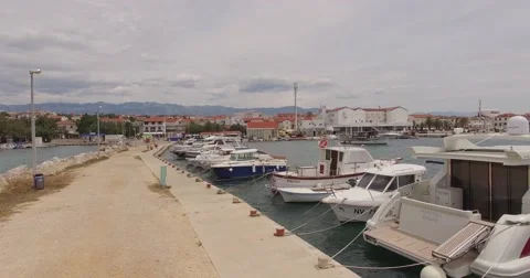 4K aerial shot DJI phantom 3 above dock at summer on holiday with ships, boats Stock Footage 54119194