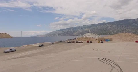 4K aerial shot DJI phantom 3 above Arriving cars to beach port at summer Stock Footage 54130829