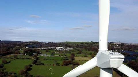 4K Aerial shot of large wind turbine up close passing through blades over Stock Footage 142604347