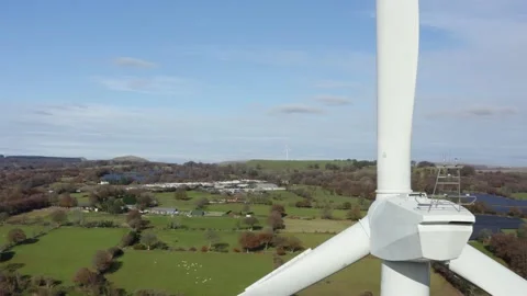 4K Aerial shot of large wind turbine up close passing through blades over Stock Footage 142647586
