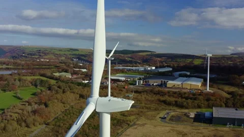 4K Aerial shot of large wind turbine up close passing through blades over Stock Footage 142760481