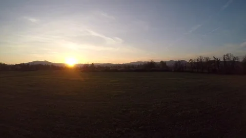 4K: Aerial shot of a meadow in setting sun Stock Footage 74884590