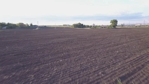 4k aerial shot Rapid flight and takeoff over the dry field near the farm Stock Footage 80759452