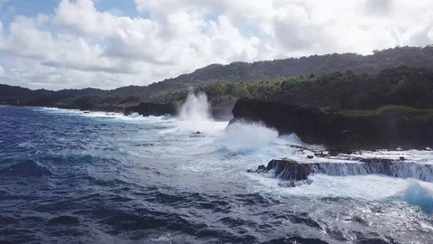 4k aerial shot of waves hitting a sea wall. Video stock 105373375