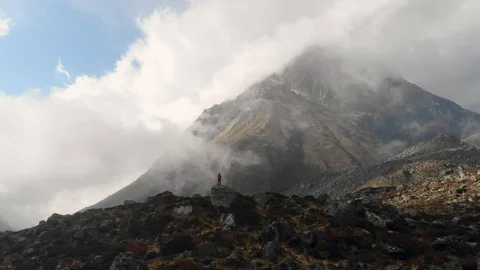4k aerial side fly with man in front of a mountain in Langtang Valley in Nepal Stock Footage 107660916