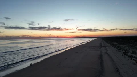 4K Aerial: Sideways drone flight along Huelva coastline at blue hour. Stock Footage 333637547