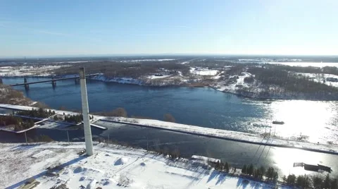 4k aerial smoke stack near water and bridge slow pan Stock Footage 58863253