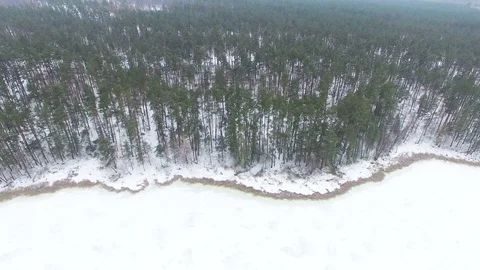  4K Aerial. Smooth flight over  frozen lake coastline. Landscape ,top view Stockbeeldmateriaal 72478877